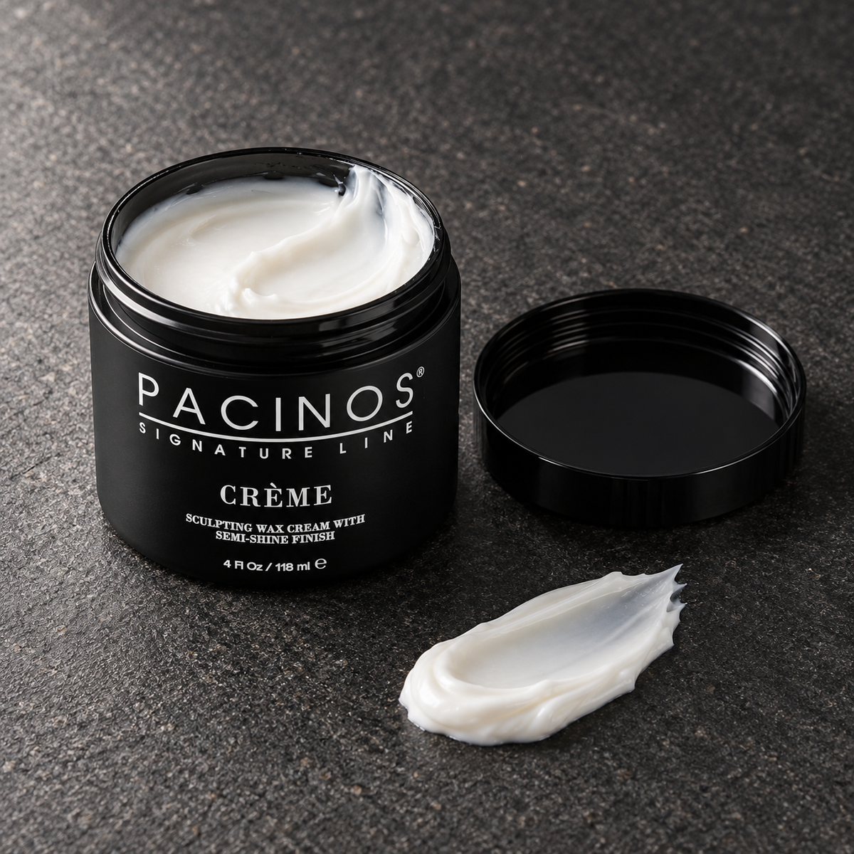 Pacinos Creme sculpting wax cream: open 4 oz jar and a swipe of the white cream on dark stone