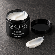 Pacinos Creme sculpting wax cream: open 4 oz jar and a swipe of the white cream on dark stone