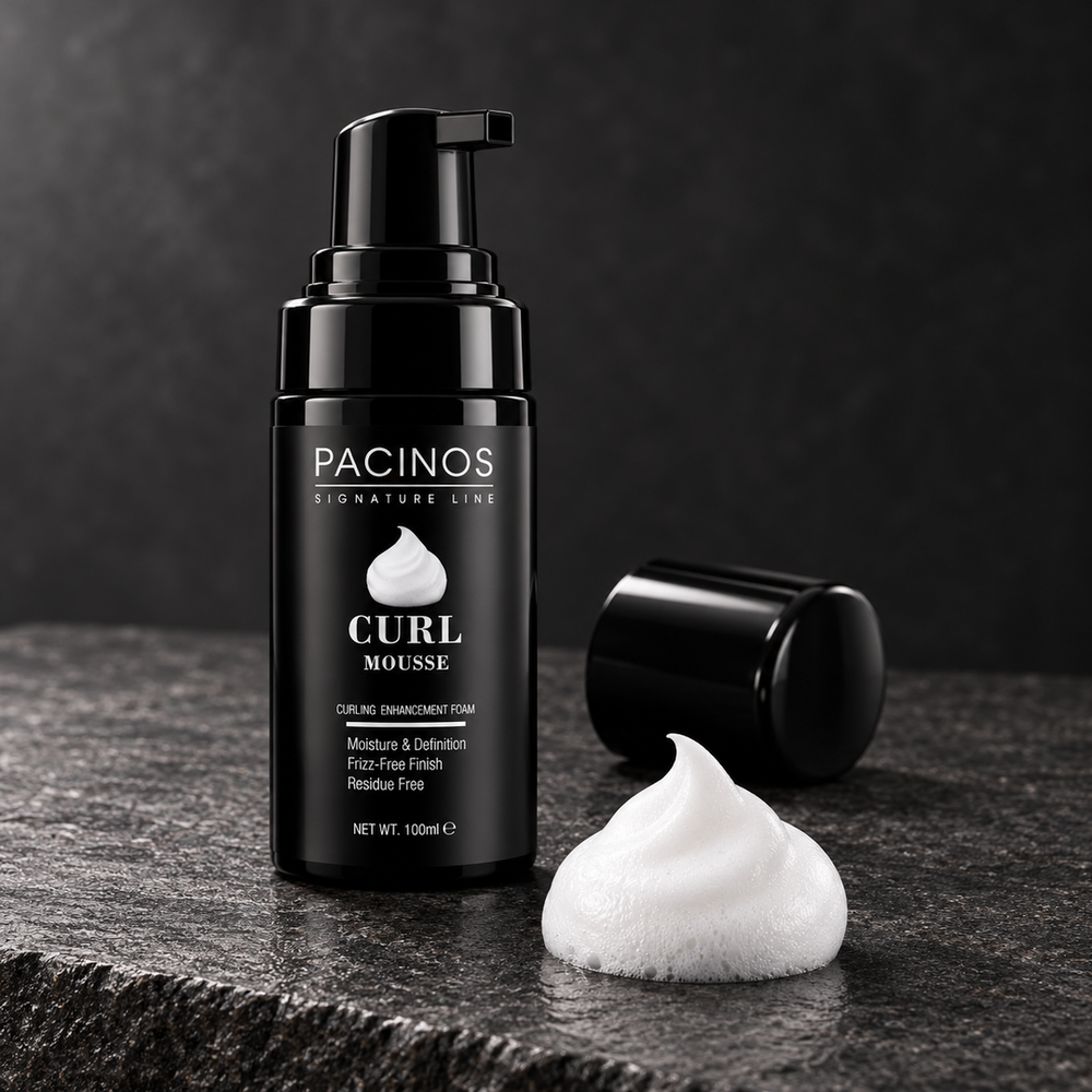 Pacinos Curl Mousse bottle beside a dollop of white foam on dark stone