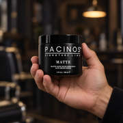 Pacinos Matte hair paste 4 oz jar held in a man's hand to show its size