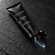 Pacinos Styling Gel 8 oz tube with a short squeeze of clear blue gel on slate