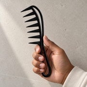 Pacinos Wide Tooth Flex comb in hand